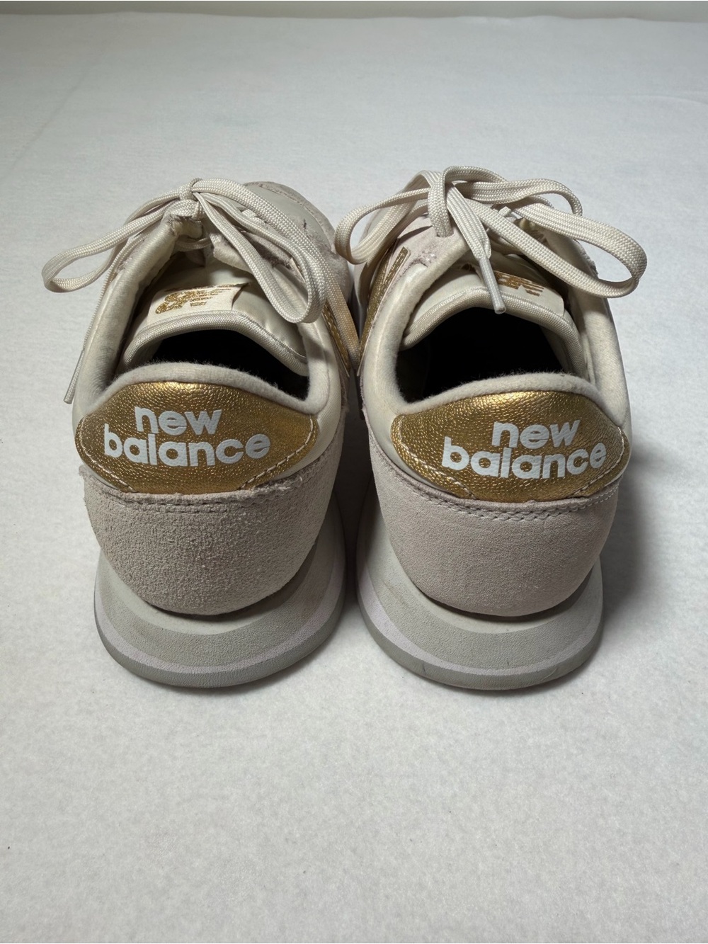 New Balance Women’s Cream Sneakers with Gold Heel Accent